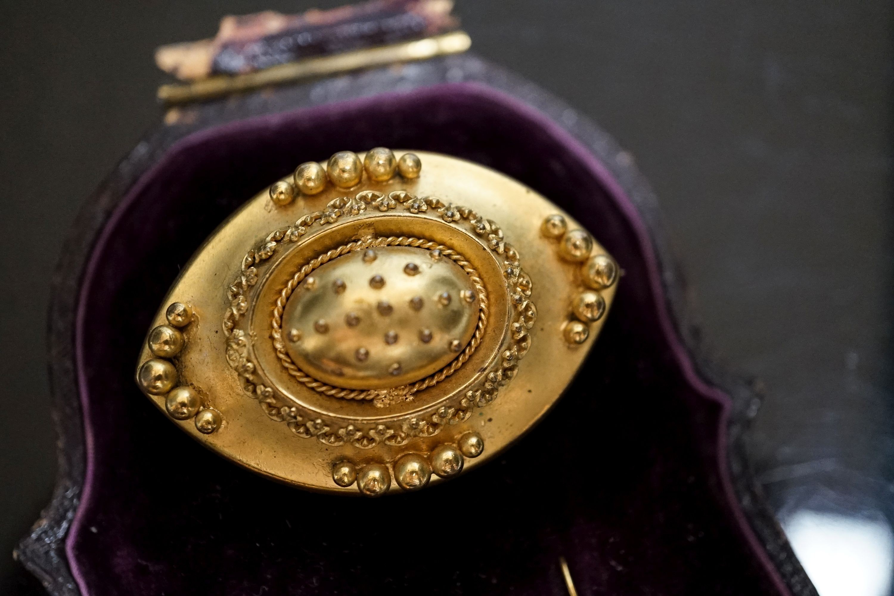 A Victorian yellow metal navette shaped brooch, with bead decoration, 46mm and a pair of similar drop earrings, 22mm, gross weight 17 grams.